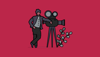 Videographer standing next to camera